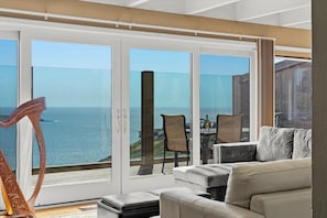 A living room that delivers: sun, comfort, and the Pacific Ocean