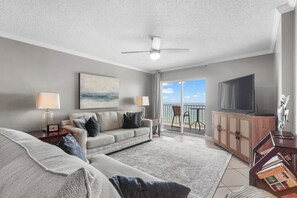 Living Area - The spacious living area features a sofa sleeper, oversized chair, and a large television for enjoying  your down time.