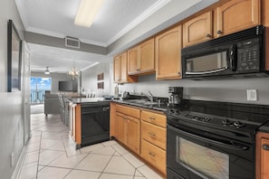 Kitchen - The spacious kitchen features electric appliances, which include a built-in microwave, smooth cooktop range, dishwasher, and refrigerator with ice maker.
A stack washer/dryer is also provided for convenience.