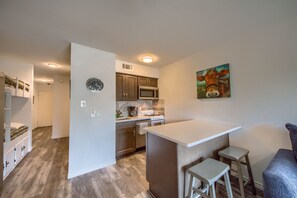 Kitchen with breakfast bar and two bar stools.