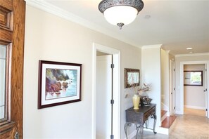 Downstairs hallway to 2 bedrooms with bathrooms and laundry room