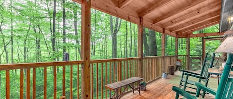 Incredible covered screen porch with rockers.