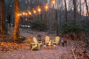 Outdoor firepit area with string lights provide a nice warm glow for hanging out