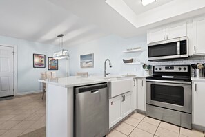 Kitchen - A fully stocked kitchen provides you with all items needed for preparing and enjoying meals during your stay.