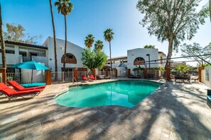 Remodeled Pool with designer travertine and newer furniture