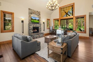 Pine Cone: - Spacious living room with a gas fireplace, and a smart TV.