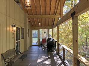 Covered entry deck area has gas grill, seating and entrances into Kitchen and Screen Porch.  Just two steps up from paved driveway.