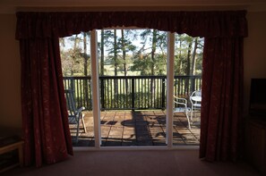 Step out through the patio doors onto your balcony with views of the countryside