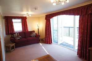 Large sitting room with triple aspect window to enjoy the view around you.