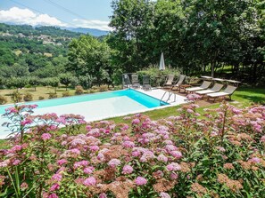 Pool and sundeck with mountain views.