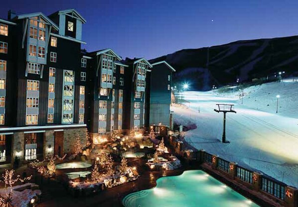 Enjoy heated pool and Multiple Jacuzzi with hot waterfalls looking at ski runs  
