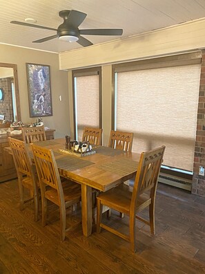 Dining area with seating for 6 at the table and 2 counter bar stools.