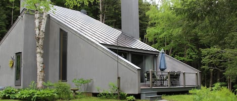 Falcon house in spring, view to deck and garden and brook