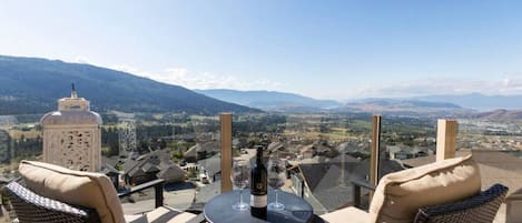 Enjoy a glass of wine on the deck with mountain and lake view