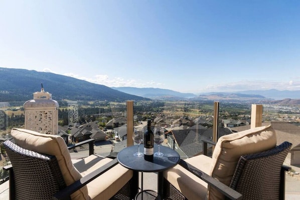 Enjoy a glass of wine on the deck with mountain and lake view