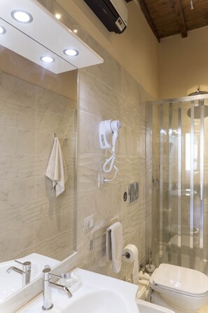 The full, ventilated bathroom with shower includes a bidet, heater, hair dryer.