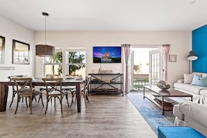 View of the living room facing the back area of the house  and the dining area