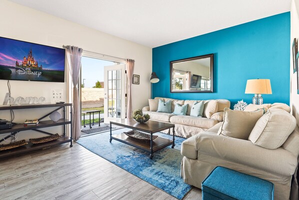 View of the living room facing the back area of the house  and the dining area