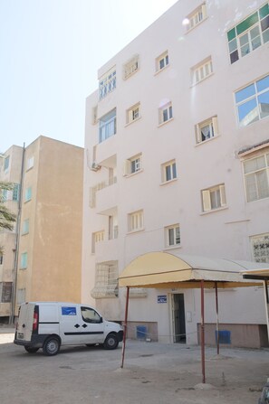behind façade, parking space