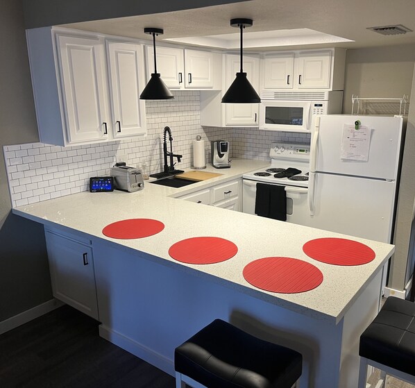 Gorgeous White Kitchen with Black Accents and Subway Tile