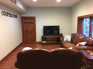 Den with large screen TV, Xbox and Wii