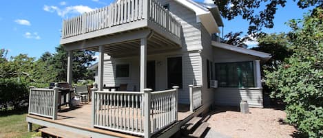 Cottage has two decks and a long private backyard extending to the dock and cove