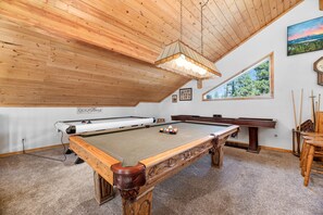 EPIC Game Room. - EPIC game room with a Pool Table, Foosball table, Air Hockey, and shuffleboard located in very nice game room that has an overview of the Living room and Kitchen WITH TWO QUEEN FUTONS!