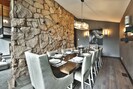 Separate dining room with large wood dining table and seating for 10.