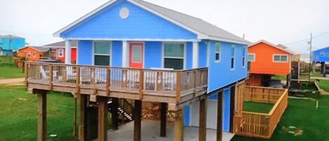 Photo of home from Hgtv. (Enhanced color) The home is light blue. 