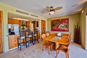 Dining, Kitchen with Breakfast bar opening up to patio.