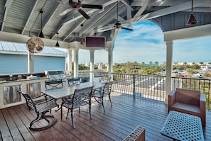 Upper Deck features a large screen TV, gas grill, gas cooktop, sink and frig