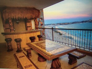 Enjoy a cocktail at the outside Tiki bar