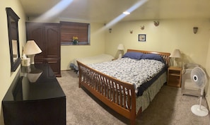 Master bedroom with 1 king bed, 1 twin bed, 1 toddler bed and a pack and play.