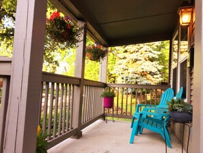 Front porch with hanging flower baskets in the summer.
