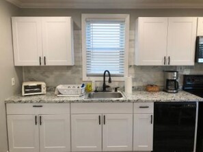 Kitchen has new cabinets, granite counter, new lighting