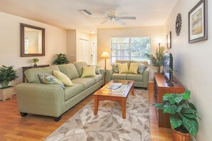 Cozy stylishly decorated living room has large flat screen HD TV, DVR and BluRay