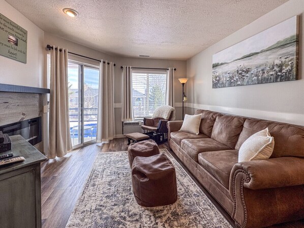 Bright, stylish retreat with comfy seating, rustic charm, and easy access to outdoor relaxation.