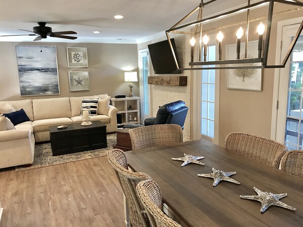 Roomy Great Room w/comfy sectional, 55” SmartTV & decorative stone fireplace.