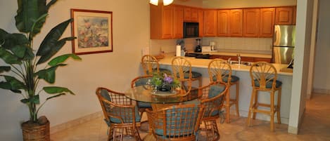 Dining area with table and chairs for four &  four bar stools with large counter