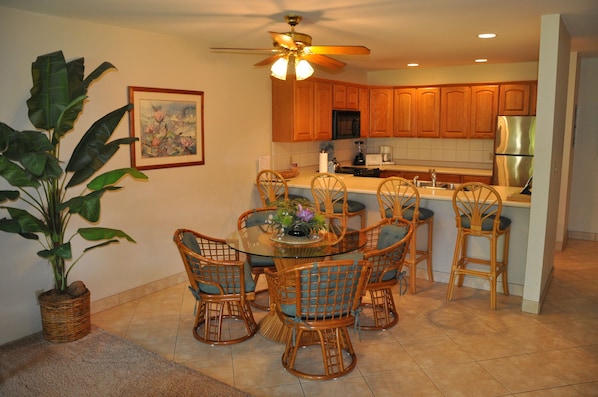 Dining area with table and chairs for four &  four bar stools with large counter