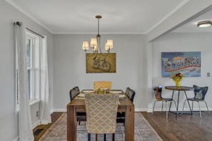 The dining table seats six and is open to both the kitchen and living room.