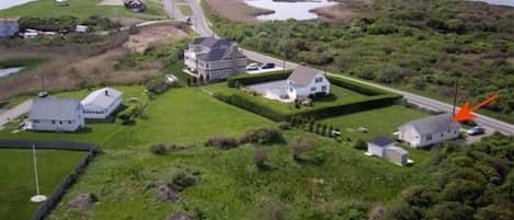 Aerial view of home.  White building with grey roof is the guest cottage.