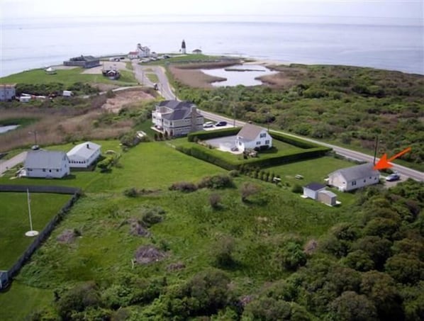 Aerial view of home. White building with grey roof is the guest cottage.