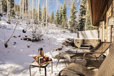 Private patio with lounge chairs and hot tub
