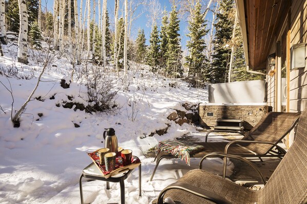 Private patio with lounge chairs and hot tub