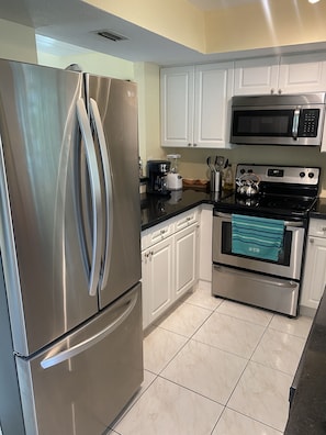 Kitchen with stainless steel appliances, granite counters, Ice maker in fridge
