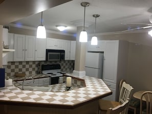 Kitchen with large sink and bar area. (Stove has been replaced w/ new glass top)