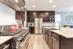 Gourmet kitchen with 6 burner gas stovetop and griddle