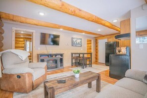 Living Room with Reclining Chair and Smart TV Looking at Dining Table