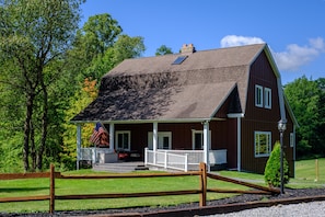 Restored 3 level home, rustic roots, with modern comforts.  Set on a sloping hill, acres of trees, fields, trails, pond, sports court, Lg front porch & back yard dining.